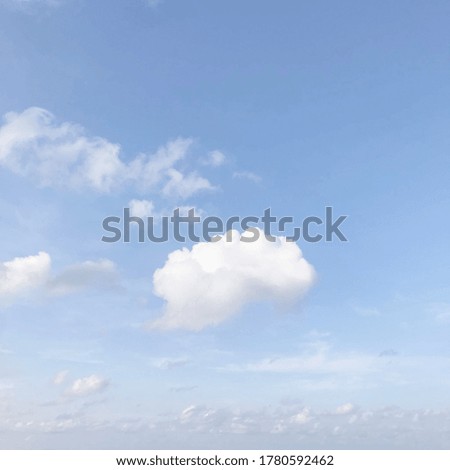 Blue sky background with tiny white clouds.