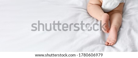 Cute little baby lying on bed, space for text. Banner design Royalty-Free Stock Photo #1780606979