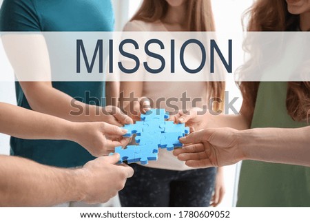 People with puzzle on light background, closeup. Mission concept