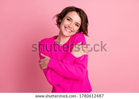 Photo of overjoyed lady good mood hands hug herself shoulders enjoy joyful soft cloth laundry warmth toothy smile wear casual bright sweater isolated pink pastel color background Royalty-Free Stock Photo #1780612487
