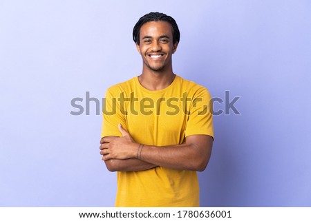 Young African American man with braids man isolated on purple background keeping the arms crossed in frontal position