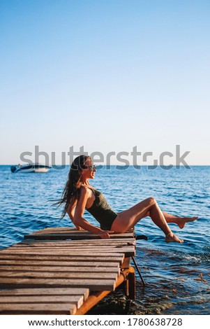 Young beautiful woman woman on the coast on the sunset