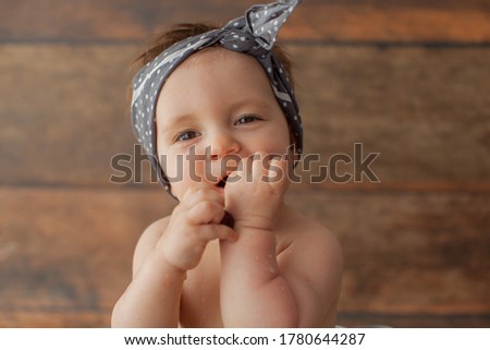One year old baby girl take a bath with fruits. Apricot in summer time. Happy Birthday photo concept. 