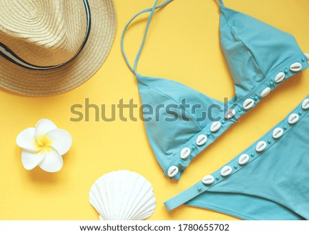 set of summer beach accessories on a yellow background.