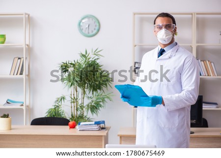 Young male doctor virologist in the office Royalty-Free Stock Photo #1780675469
