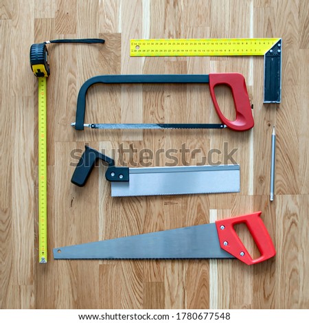 The set of construction tools includes different saws, measuring tools, tape measure, pencil, corner for use in manufacturing process industrial sector. Home repair their own hands