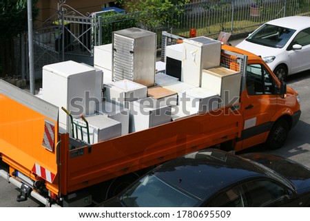 Electronic waste, disposal, collection of refrigerators, cooling devices, transport to the recycling center, disposal of white goods Royalty-Free Stock Photo #1780695509