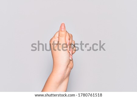 Hand of caucasian young woman holding blank space with thumb finger, business and advertising