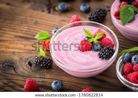 Fresh berry fruit yogurt with forest fruits and mint