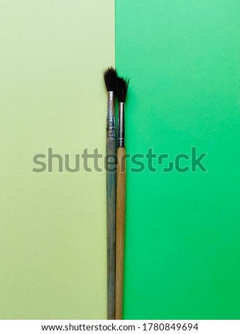 paintbrushes on yellow green background