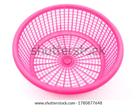 Top view, small pink plastic basket on a white background.