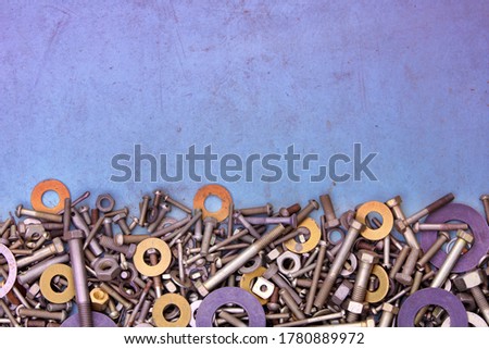 Abstract grunge colorful metallic background from bolts, screws, nuts