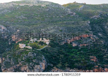 View of villages in the hill near the Porto Kagio in Mani Peninsula, Laconia, Greece. Colorful sea water and green mainland in Mani Peninsula.