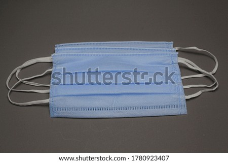 Blue Face Mask On Gray Background.