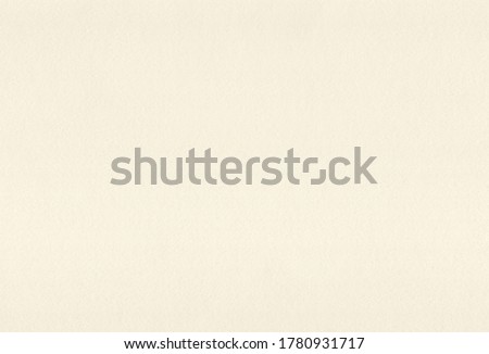 Sheet of textured pale yellow coloured creative paper background. Extra large highly detailed image.