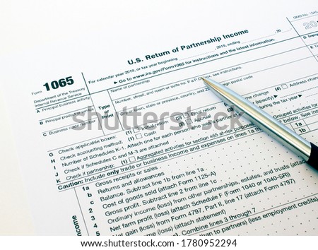 US tax form 1065 with a silver pen Royalty-Free Stock Photo #1780952294
