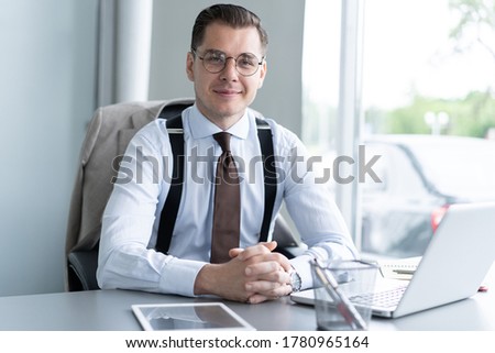Handsome businessman working with laptop in office.