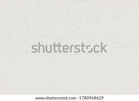 Grey paper recycled background with inclusions of paper particles. Extra large highly detailed image. Recycled paper concept.