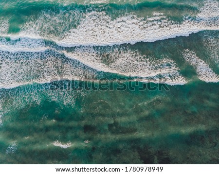 Aerial drone view of epic emerald waves of the Atlantic Ocean