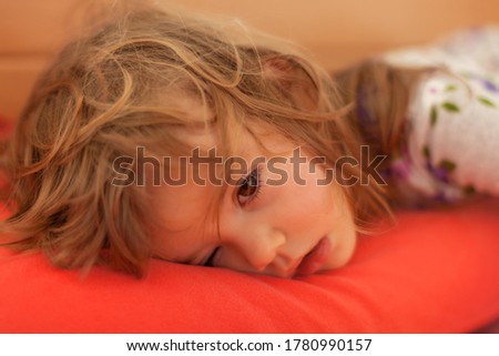little girl  sleeping on the big bed, note shallow depth of field