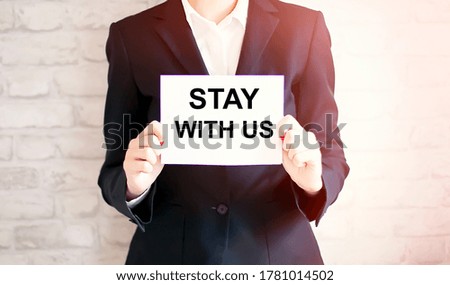 woman showing white card with STAY WITH US word . Business concept