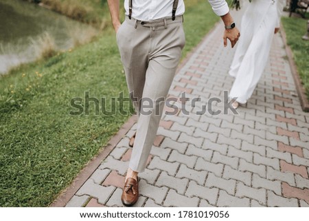 
legs of the bride and groom, wedding shoes, wedding bouquet, walk 
holding hands, clock