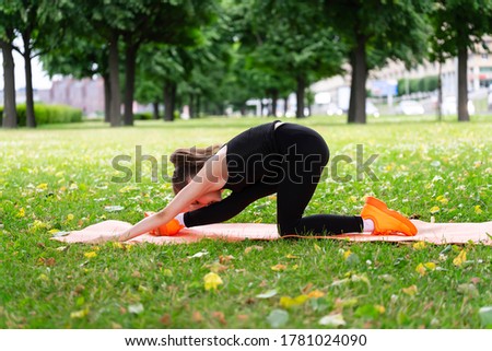 Gymnast schoolgirl warming up in a grass park before performing complex exercises. Series of photos