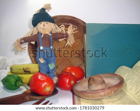 Scarecrow doll with fruits and books