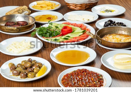 Special Turkish Breakfast. Organic,fresh Traditional Turkish Village Breakfast on the wooden table with copper egg pan,ceramic casserole and porcelain breakfast set.
