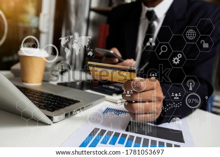 Businessman using a credit card on network connection and virtual screen interface icons, Technology digital concept, Blurred background.
