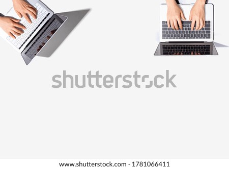 Two people working together with laptop computers