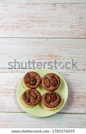 chocolate tart brownies with raisins on green dish - stock photo