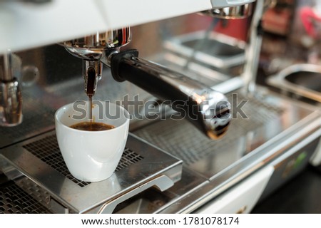 black coffee in white cup put on coffee maker