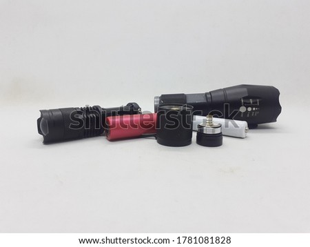 Black Electric LED Flashlight Powered by Rechargeable Battery in White Isolated Background