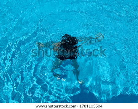 Boy diving underwater in swimming pool