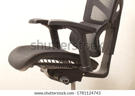 black office ergonomic chair with mesh coating clear seat Royalty-Free Stock Photo #1781124743