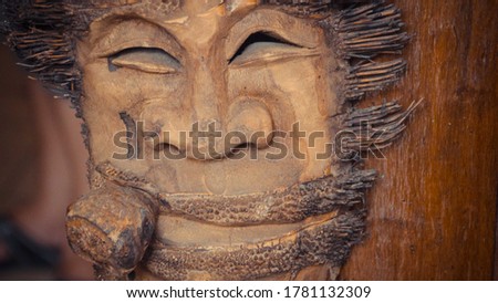 Close up of a face sculptured on a wood