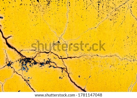 Old cracked painted yellow or orange wall