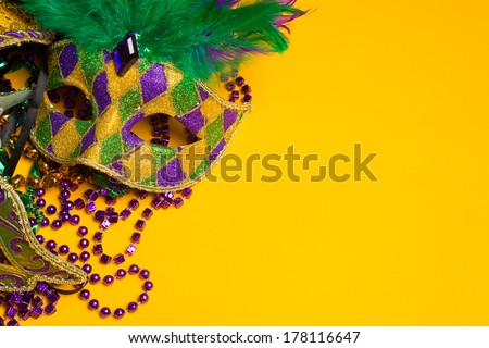 A festive, colorful group of mardi gras or carnivale mask on a yellow background.  Venetian masks. Royalty-Free Stock Photo #178116647