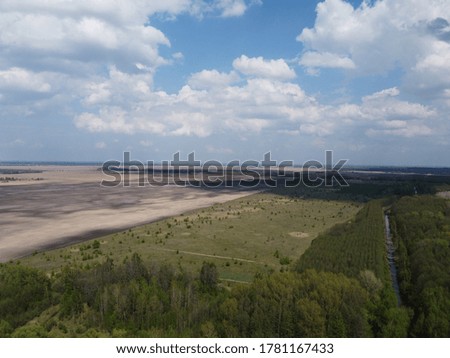 Beautiful blue sky over woodland, aerial view. Agricultural land.