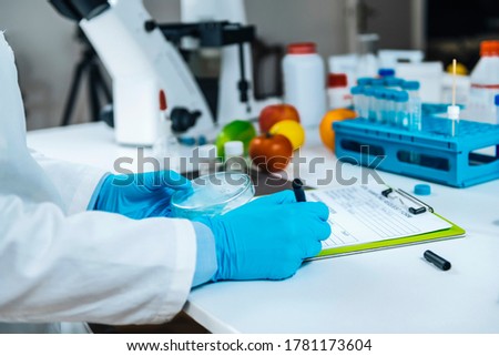Food Quality Assessment in Microbiology Laboratory, microbiologist filling forms, following standard operating procedure  Royalty-Free Stock Photo #1781173604