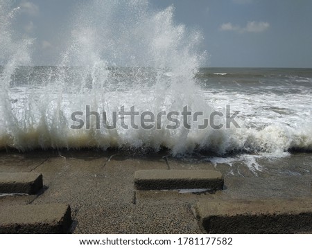 Power of Sea Waves, splashing on the concrete bank