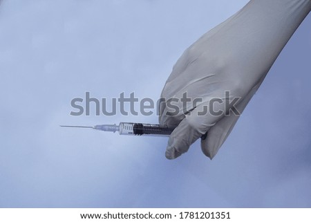 syringe in hands of a nurse 