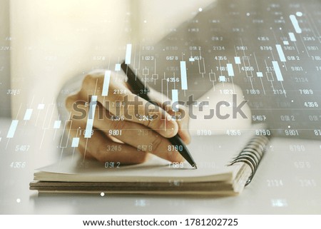 Multi exposure of stats data illustration with man hand writing in notebook on background, computing and analytics concept