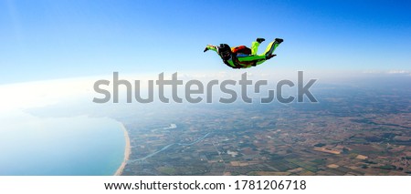 Skydiver free fall parachute man. Skydiving free fall man. Space games background sunset