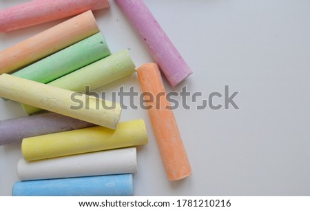 Colorful chalks isolated on white background, top view.

