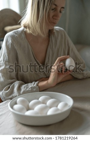 Woman cooking on kitchen. Diet, healthy, organic food cooking - female chef holds in hands eggs. High quality photo