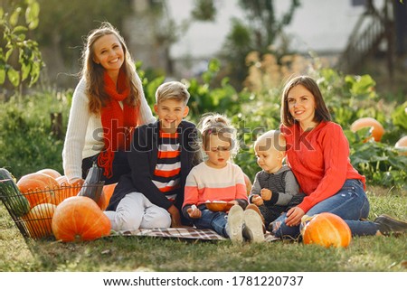 Family in a garden. People with pumpkins. Children with parents