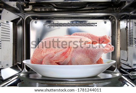 chicken defrosting using microwave oven Royalty-Free Stock Photo #1781244011