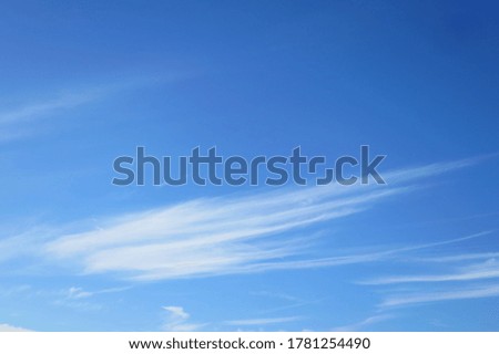 Clear blue sky with white clouds in summer time. Nature background with copy space concept.